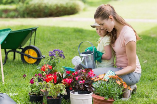 Gardener carrying out routine garden maintenance and pruning