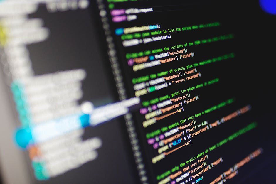 A close-up view of a computer screen displaying multicolored lines of programming code in a text editor, with visible syntax highlighting and text formatting. The screen shows a dense arrangement of c
